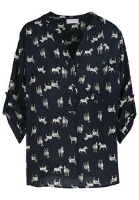 Blouse marine à imprimé zèbre blanc intégral, décolleté en V, manches longues avec revers, et une poche poitrine unique. Tissu léger.