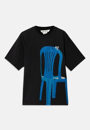 Black cotton T-shirt featuring a blue printed chair design on the front. Short sleeves and a round neckline. Simple text above the chair.
