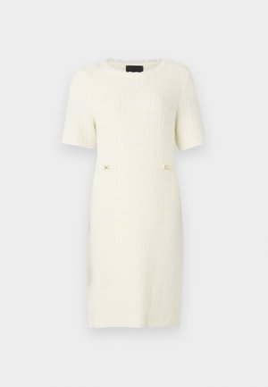 Valkoinen lyhythihainen tekstiilikoristeinen mekko, jossa on neliökuvio ja kaksi pientä kultasävyistä yksityiskohtaa vyötäröllä. Pyöreä pääntie.