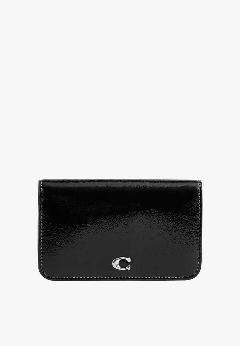 Portefeuille en cuir noir brillant avec un petit emblème argenté "C" centré sur le rabat avant, forme rectangulaire avec des coins arrondis.