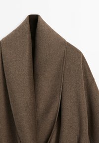Brown wool coat with wide shawl collar shown against a white background.