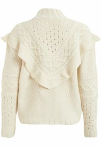 Pull en tricot crème avec col à volants, motifs texturés et accents en tricot torsadé. Le dos présente des points ouverts pour un look superposé.