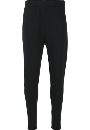 Zwarte joggers gemaakt van zachte, rekbare stof. Voorzien van een elastische tailleband, twee zijzakken en een taps toelopend ontwerp.