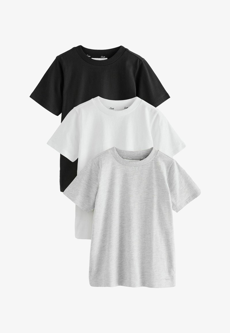 Trois t-shirts unis à manches courtes et col rond empilés, en noir, blanc et gris clair, présentés sur un fond blanc.