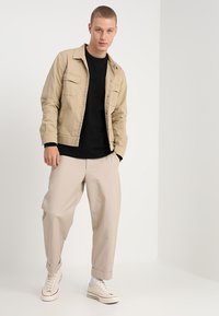 Carhartt WIP CHASE - Hosszú ujjú felső - black/gold