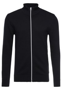 Svart zip-up tröja med hög krage, med ribbat mönster och en kontrasterande silverdragkedja, tillverkad av ett mjukt stickat material.