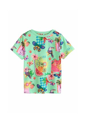 Short-sleeve mint green children's t-shirt with colorful tropical print including butterflies, toucans, fruits, flowers, and text "Hola Adios".