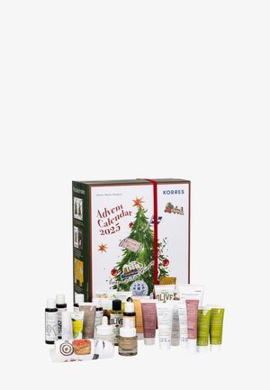 Advent calendar box in multicolors features festive tree illustration, red ribbon, with 24 skincare products in various sizes and colors.