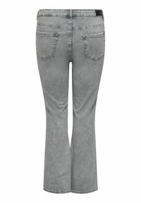 Pantalones vaqueros de mezclilla gris con bolsillos traseros y costuras sutiles, mostrados desde atrás con un corte de pierna ligeramente acampanado.