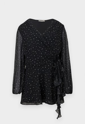 Blouse noire transparente à manches longues avec un motif d'étoiles argentées et un détail de nœud froncé sur le côté.