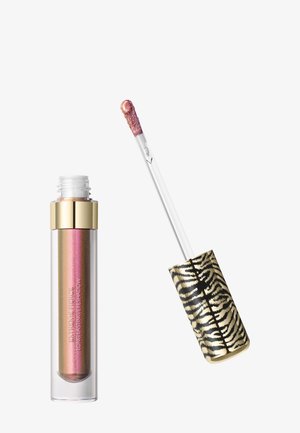 Ombre à paupières liquide rose-doré scintillante avec capuchon doré et couvercle imprimé léopard, applicateur partiellement retiré montrant le produit au bout.