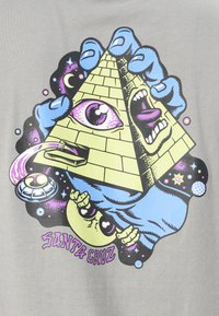 Gray T-shirt featuring a graphic design of a yellow pyramid, an eye, and hands with vibrant colors and cosmic elements, labeled "Santa Cruz."