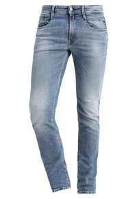 Light blue denim jeans with a slim fit. Features five pockets, a button closure, and subtle fading across the fabric.