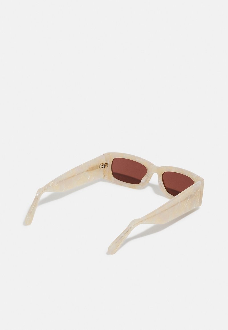 Sunglasses with a translucent honey-colored frame, rectangular brown lenses, and structured arms featuring a subtle marbled texture.