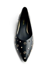 Zapato plano de cuero negro con punta afilada, que presenta acentos de metal dorado y un patrón de recortes circulares en toda la superficie.
