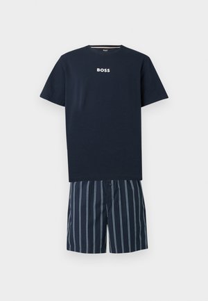 Μπλε στρατιωτικό κοντομάνικο T-shirt με το κείμενο "BOSS" σε συνδυασμό με μπλε στρατιωτικές και λευκές κάθετες ριγέ σορτς.