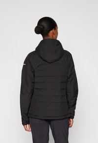 Black insulated jacket with a hood, featuring a quilted design, elastic cuffs, and a smooth texture. The back has a curved seam detail.