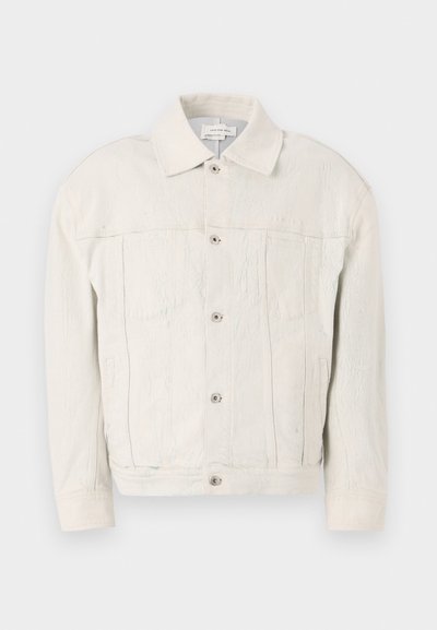 Giacca in denim bianco con un design strutturato, dotata di colletto a punta, chiusura a bottoni e linee di texture visibili per un dettaglio aggiuntivo.