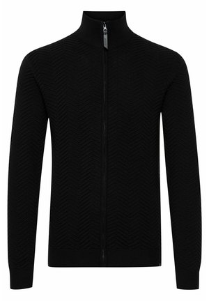 Zwarte zip-up sweater met een hoge kraag, voorzien van een gestructureerd zigzagpatroon en ribgebreide manchetten en onderkant. Gemaakt van gebreid materiaal.