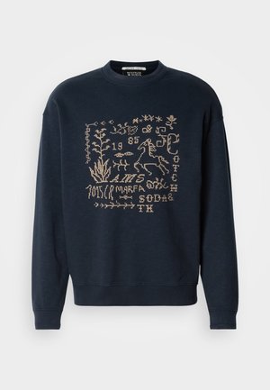 Felpa blu navy realizzata in morbido tessuto, con design ricamati color sabbia di piante e un cavallo. Collo rotondo e polsini a coste.