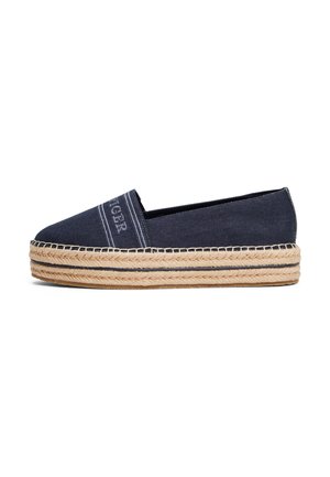 Alpargata azul marino tipo slip-on con suela plataforma de yute trenzado y texto "TIGER" bordado en la parte superior delantera.