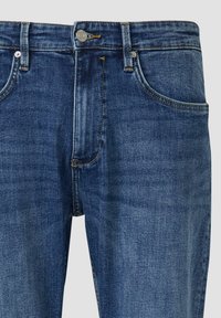 Jeansy z ciemnoniebieskiego denimu o prostym kroju, z zamkiem błyskawicznym, pięcioma kieszeniami i kontrastowymi przeszyciami.