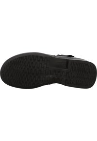 Suola di scarpa nera con motivo di presa testurizzato, design piatto, punta arrotondata e senza marchi visibili. Il materiale sembra gomma con una leggera flessibilità.