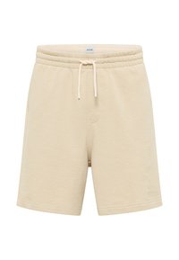 Beige cotton shorts with an elastic waistband, adjustable drawstring, and subtle logo detail on the hem. Smooth texture, casual design.