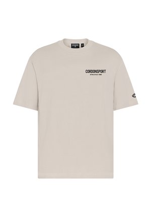 Beiges T-Shirt mit kurzen Ärmeln mit dem Text "CORDONSPORT ATHLETICS 1986" auf der Brust und einem kleinen Logo auf dem linken Ärmel.