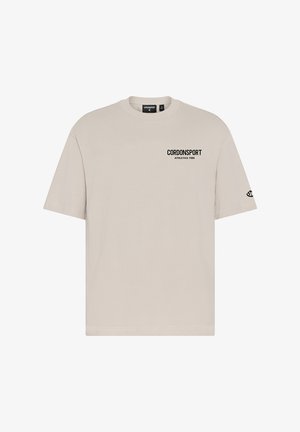 Beiges T-Shirt mit kurzen Ärmeln mit dem Text "CORDONSPORT ATHLETICS 1986" auf der Brust und einem kleinen Logo auf dem linken Ärmel.
