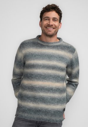 Striped sweater in shades of gray and cream, made of soft wool, featuring a crew neckline and ribbed cuffs and hem. Relaxed fit.