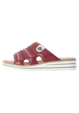 Red leather slide sandal with three curved straps, open toe, and circular metal accent. Features a textured cork footbed and white striped sole.