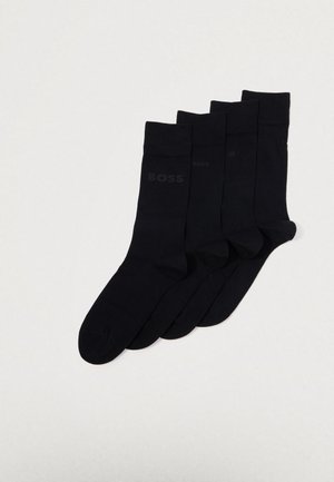 Set of four black cotton socks. Features a smooth texture, thin ribbed cuffs, and a subtle "BOSS" logo near the ankle.