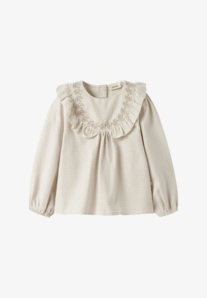 Krémová blúzka s dlhým rukávom s drobným károvaným vzorom, volánikový golier a kvetinová výšivka pozdĺž okraja goliera, elastické manžety a zapínanie na gombíky vzadu.