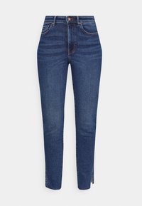 Tajta, mörkblå denimjeans med knäppning, framfickor och sidosprund i kanten. Strukturerad tyg med subtila blekningar.