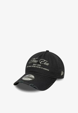 Zwarte verstelbare New Era pet met witte geborduurde tekst "New Era Est. 1920 New York, United States of America" en versleten rand aan de klep.