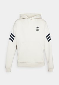 Cremefarvet hoodie lavet af blødt stof, med en stor frontlomme, adidas- og Star Wars-logoer samt marineblå tre-stribede detaljer på ærmerne.
