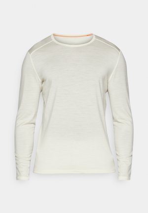Langermet skjorte i kremfarge, med rund hals, oransje søm og glatt tekstur. Enkelt design uten ytterligere mønstre.