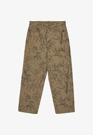 Cotton trousers in a tan color, featuring a dark brown tree branch pattern. Straight-leg design with front pockets and button closure.