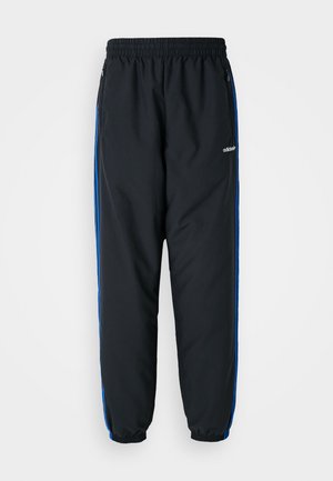 Black athletic pants with elastic waistband, blue side stripes, zippered pockets, and tapered cuffs for a snug fit. Made of lightweight material.