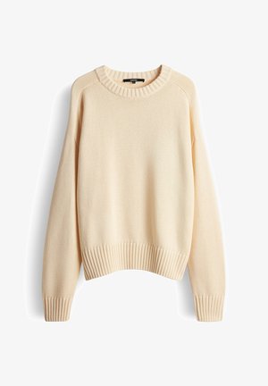 Maglione lavorato a maglia color beige chiaro con scollo rotondo, orlo e polsini a coste. Presenta un motivo a trama e spalle scese.