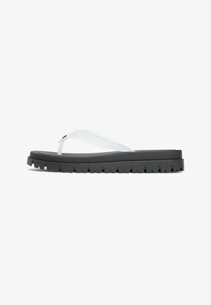 Black thick-soled flip-flop sandal with clear wide plastic straps and rugged tread sole, shown from side on white background.