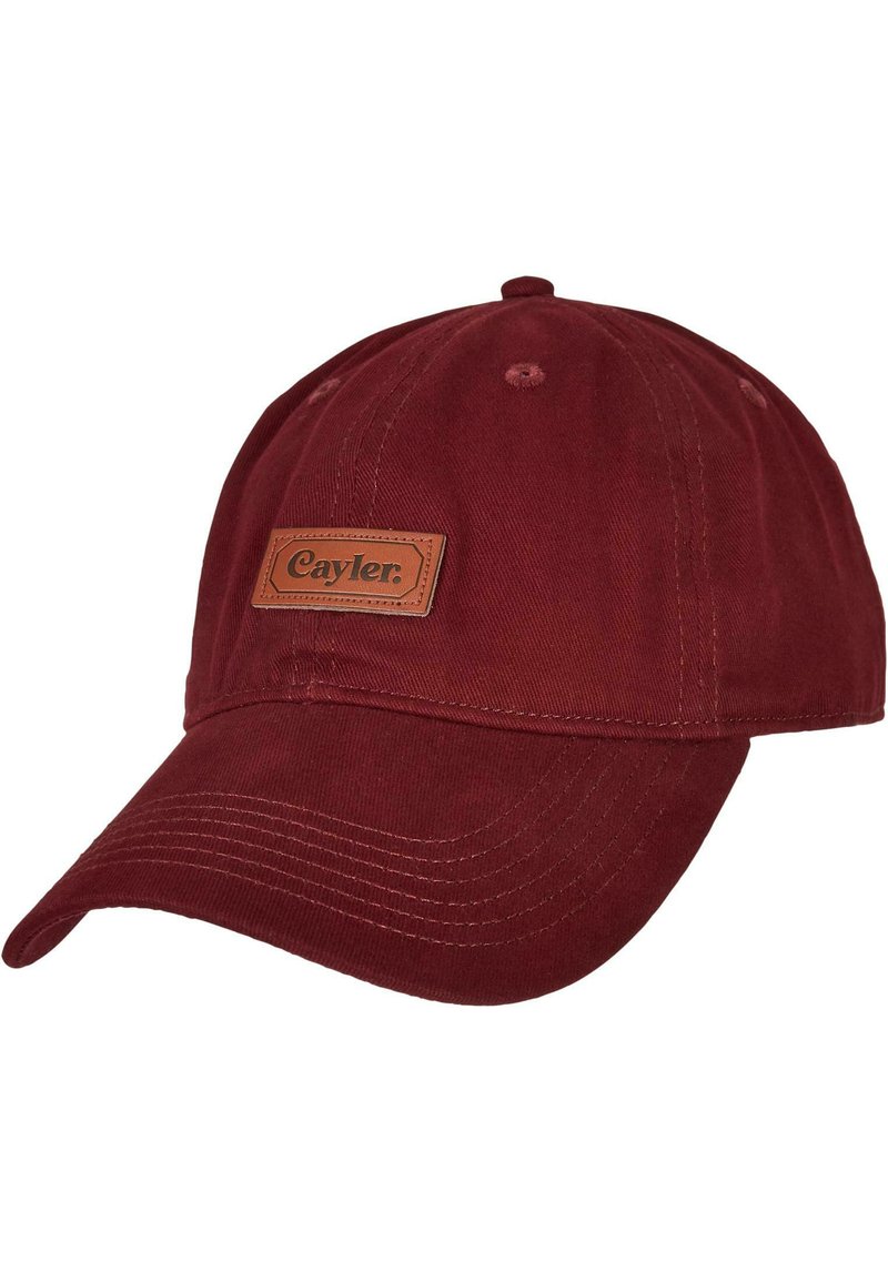 Maroon cotton cap with a curved brim, featuring a brown leather patch labeled "Cayler." Visible stitching and eyelet vents for breathability.