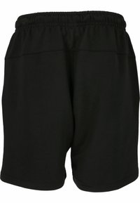 Svarta sportshorts gjorda av mjukt tyg, med resårmidja och minimala sömmar. Längden är mitt på låret med en avslappnad passform.