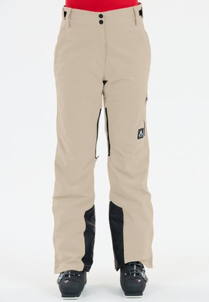 Beige wasserdichte Skihose mit schwarzen Akzenten, Reißverschlusstaschen und taillierter Passform. Mit Knöpfen an der Taille befestigt.