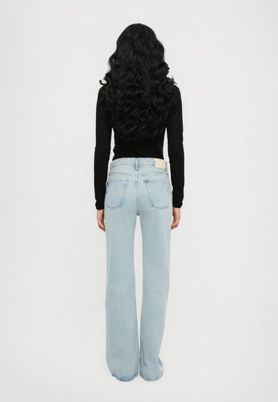 Light blue wide-leg jeans made of denim, featuring a high waist, two back pockets, and a straight cut with a raw hem.