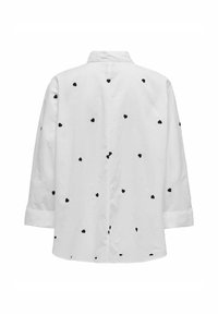 Camicia bianca a maniche lunghe, con colletto button-down e ricami a forma di cuori neri sparsi sulla schiena. Texture in cotone morbido.