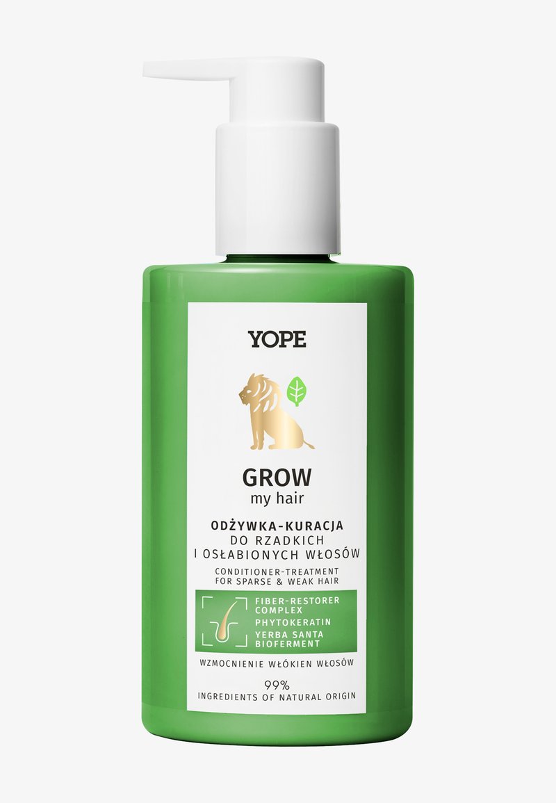 Bouteille en plastique verte avec un distributeur à pompe blanc, arborant un logo de lion et un texte indiquant un soin après-shampoing pour cheveux fragiles.