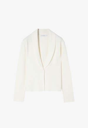 Valkoinen lyhyt villatakki, joka on valmistettu pehmeästä kankaasta. Siinä on huivikaulus, pitkät hihat ja edessä yksi nappi.