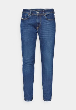 Blaue Denim-Jeans mit tailliertem Schnitt, fünf Taschen, kontrastierenden gelben Nähten und einem leichten Ausbleichungseffekt an den Beinen.
